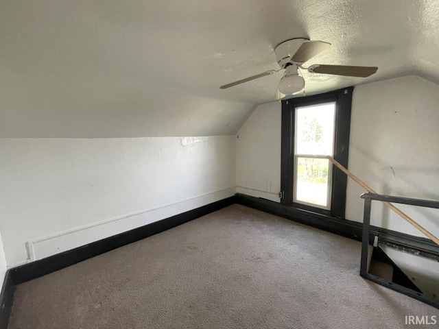 251 N Snowden St, Andrews, IN 46702 - additional living space featuring lofted ceiling, a ceiling fan, carpet floors, baseboards, and a textured ceiling
