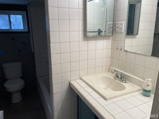 251 N Snowden St, Andrews, IN 46702 - full bathroom with tile walls, toilet, vanity, and backsplash