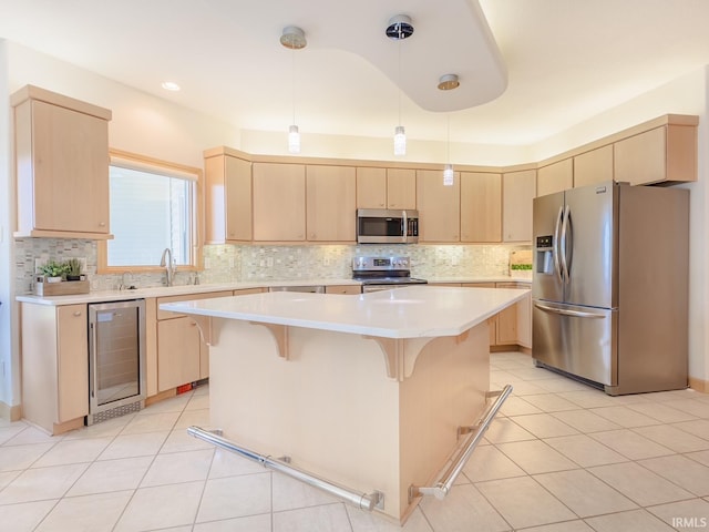 kitchen with stainless steel appliances, wine cooler, light brown cabinets, and a sink