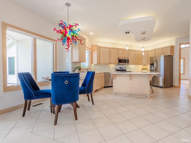 dining space with baseboards and light tile patterned floors