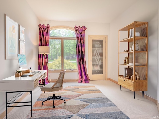 carpeted office space with baseboards