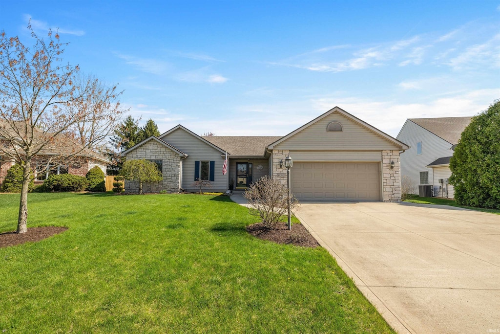 2009 Winding Creek Ln, Fort Wayne, IN 46804 - ranch-style home featuring an attached garage, driveway, central AC unit, a front yard, and stone siding