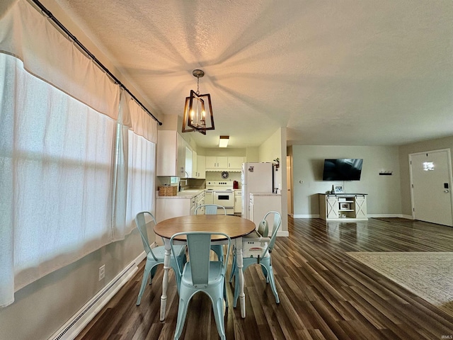 dining room featuring baseboards, a chandelier, a textured ceiling, and dark wood-style flooring