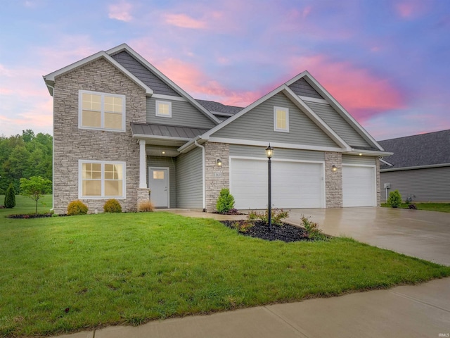 13655 Copper Strike Pass, Fort Wayne, IN 46845 - view of front facade featuring stone siding, driveway, a standing seam roof, and a yard