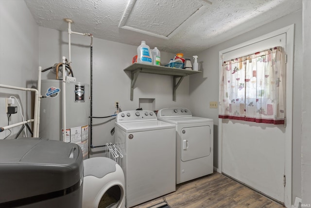 laundry room featuring independent washer and dryer, wood finished floors, and a textured ceiling