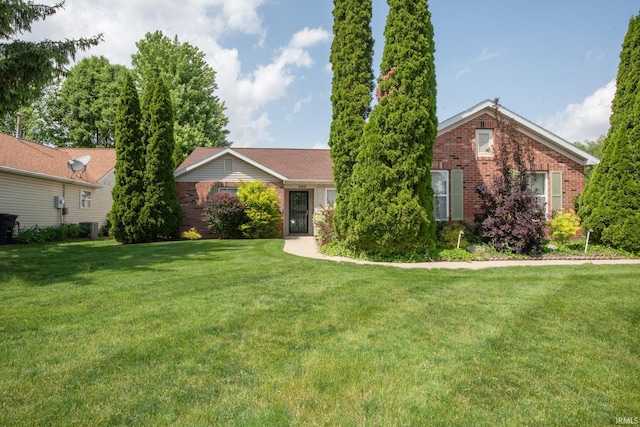 5148 Stable Dr, Lafayette, IN 47905 - view of front facade featuring brick siding, a front lawn, and central AC