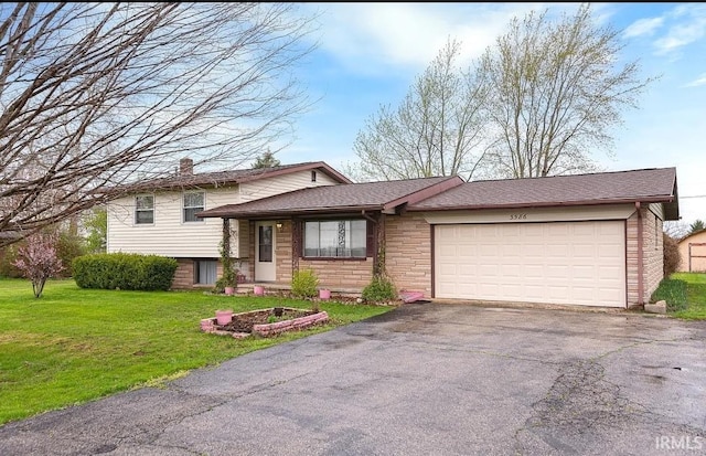 3586 E 100 S, Kokomo, IN 46902 - split level home featuring driveway, a garage, a front yard, and brick siding