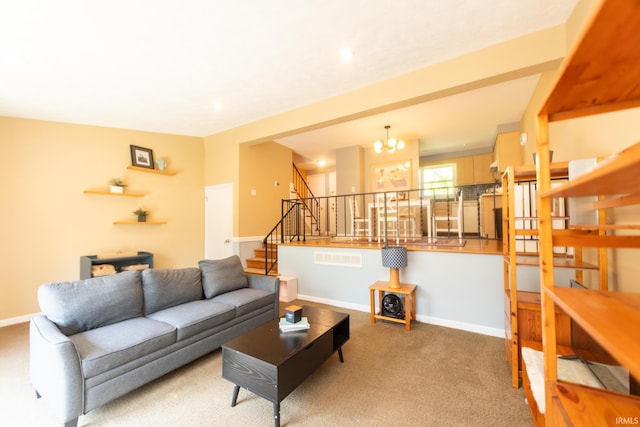 carpeted living area with stairway, baseboards, and a chandelier