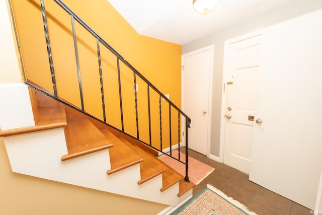 foyer entrance with tile patterned floors and stairs
