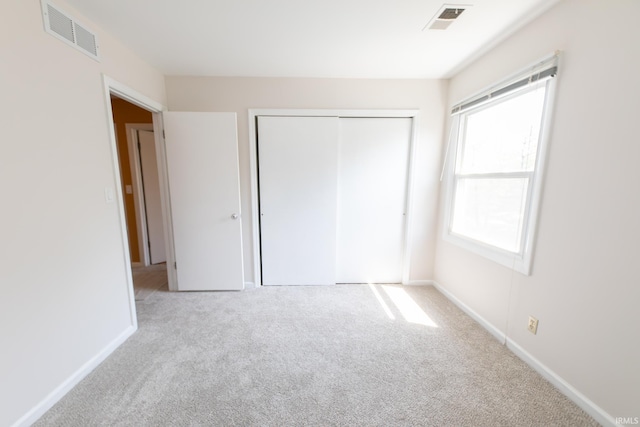 unfurnished bedroom with carpet flooring, a closet, and baseboards