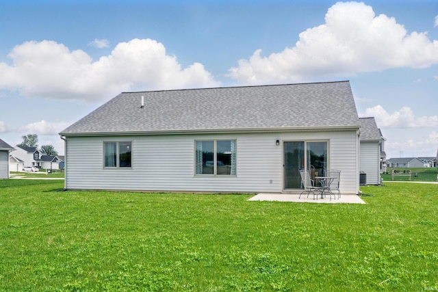 1806 Waynedale Dr, Garrett, IN 46738 - back of property featuring a patio, a lawn, and a shingled roof
