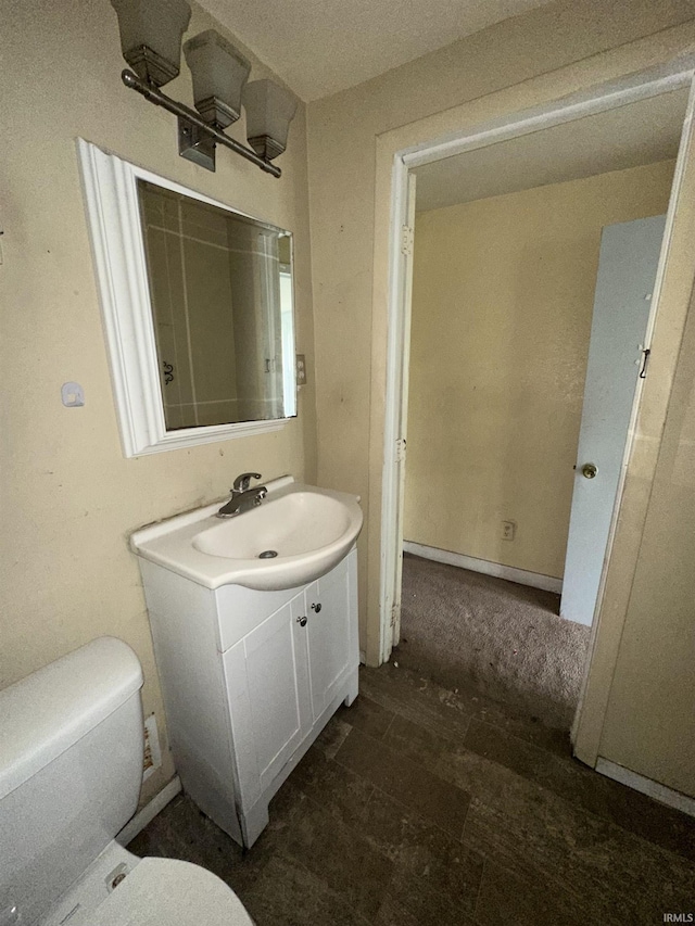 bathroom with toilet and vanity