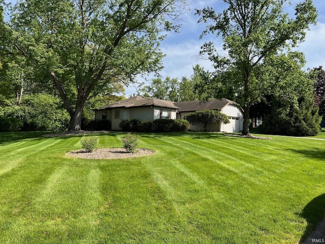 211 Mccutcheon Dr, Lafayette, IN 47909 - view of grassy yard with an attached garage