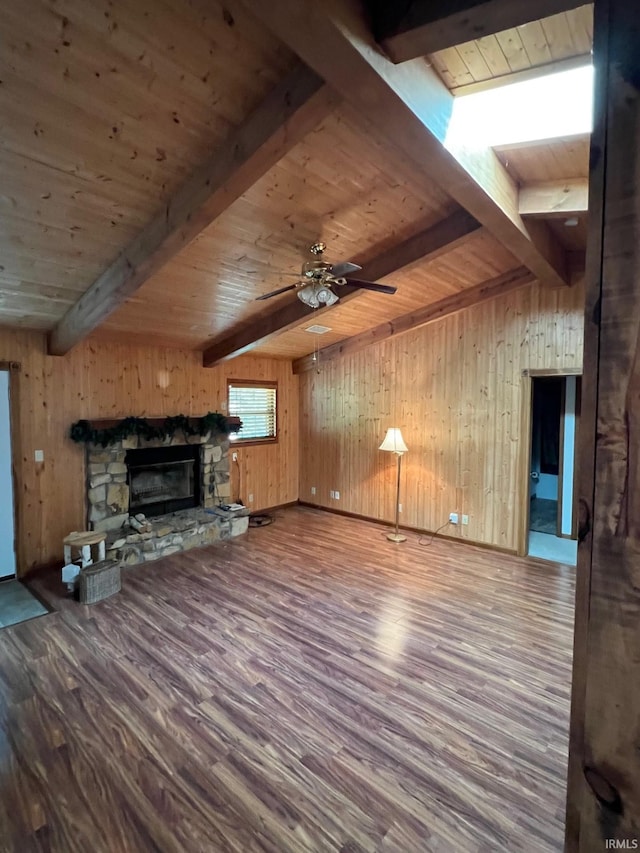 211 Mccutcheon Dr, Lafayette, IN 47909 - unfurnished living room featuring wooden ceiling, beamed ceiling, wood finished floors, wood walls, and a fireplace