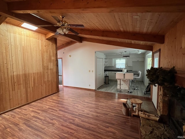 211 Mccutcheon Dr, Lafayette, IN 47909 - living room with wooden walls, light wood-style flooring, a ceiling fan, and baseboards