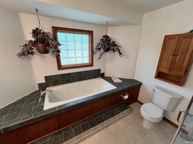211 Mccutcheon Dr, Lafayette, IN 47909 - bathroom featuring toilet, tile patterned floors, a whirlpool tub, and baseboards