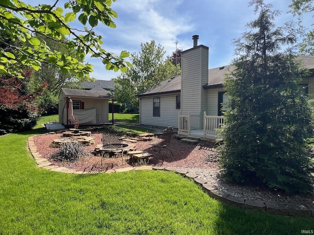 211 Mccutcheon Dr, Lafayette, IN 47909 - view of green lawn with an outdoor structure, an outdoor fire pit, and a shed