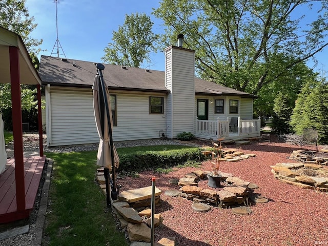 211 Mccutcheon Dr, Lafayette, IN 47909 - back of house featuring a fire pit, a deck, a chimney, and a shingled roof