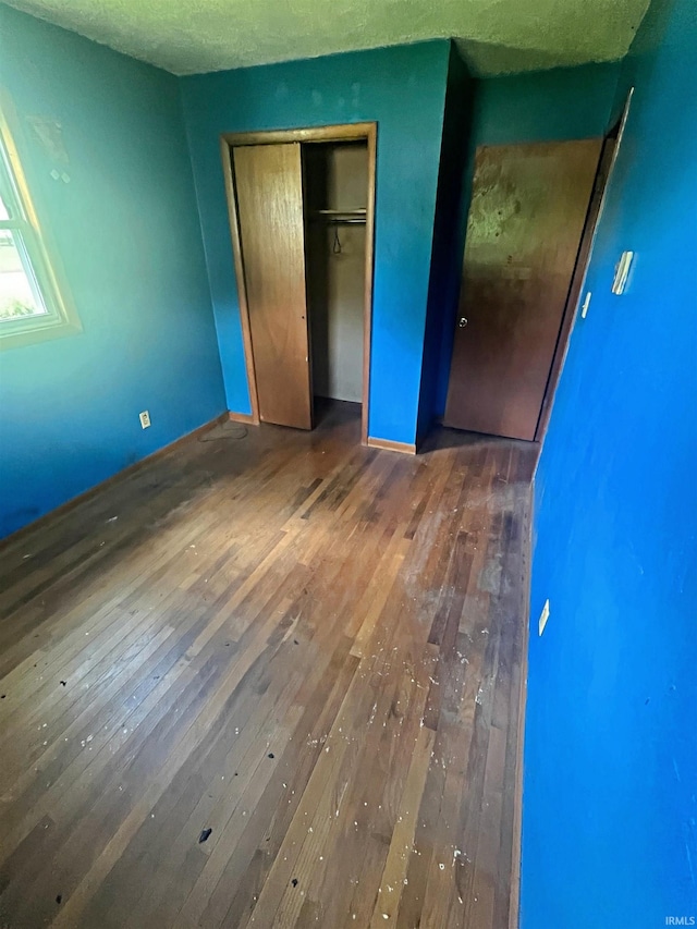 508 Walker St, Loogootee, IN 47553 - unfurnished bedroom with wood-type flooring and a closet