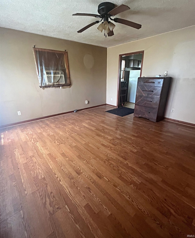508 Walker St, Loogootee, IN 47553 - unfurnished living room featuring wood finished floors, ceiling fan, a textured ceiling, and baseboards
