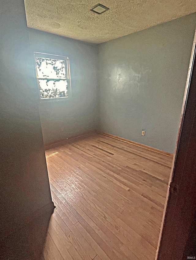 508 Walker St, Loogootee, IN 47553 - unfurnished room with wood finished floors, a textured ceiling, and baseboards
