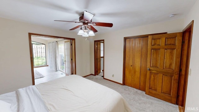 601 E 21st St, Ferdinand, IN 47532 - bedroom with light colored carpet, a closet, a ceiling fan, baseboards, and access to exterior