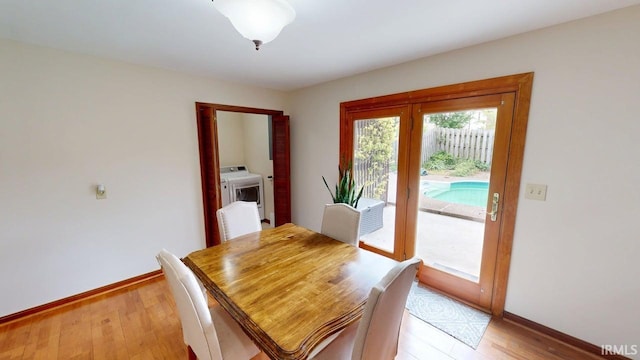 601 E 21st St, Ferdinand, IN 47532 - dining space featuring washer / clothes dryer, baseboards, and light wood finished floors