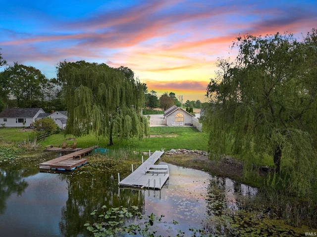 dock with a water view and a lawn
