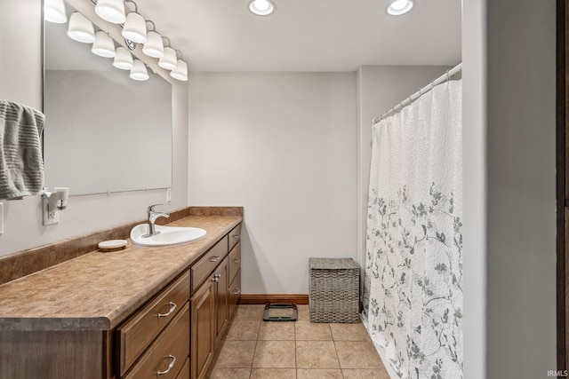 full bath with vanity, recessed lighting, tile patterned flooring, and baseboards
