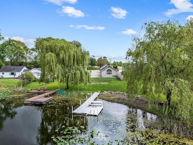 dock featuring a water view and a lawn