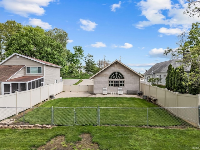 rear view of house with a gate and a patio
