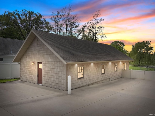 garage at dusk with fence