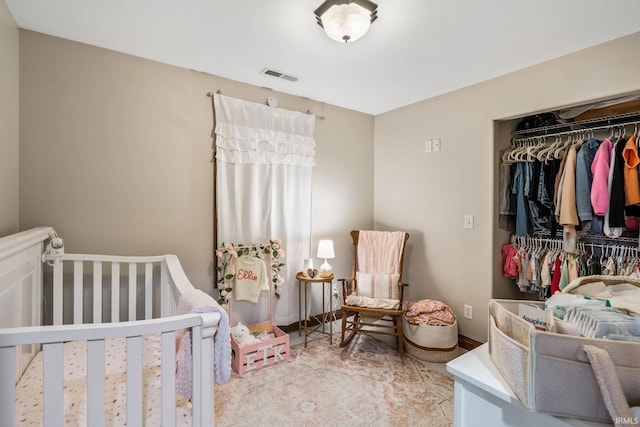 bedroom featuring a closet and a nursery area