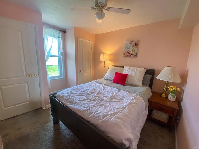 carpeted bedroom featuring ceiling fan and baseboards