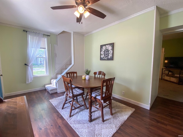 dining space with dark wood-style flooring, ceiling fan, stairway, crown molding, and baseboards