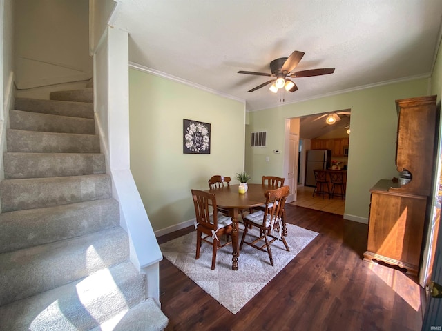 dining area with ceiling fan, stairway, wood finished floors, ornamental molding, and baseboards