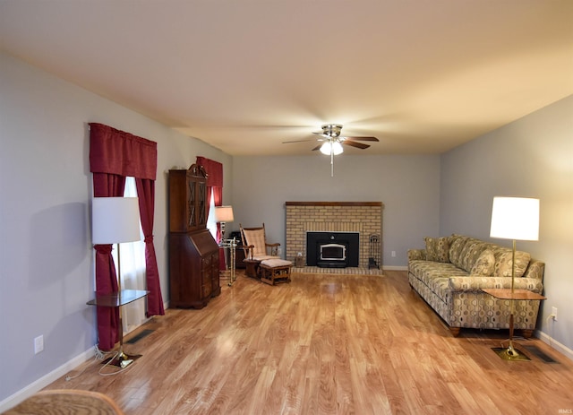 4101 Saddlebrooke Ln, Evansville, IN 47715 - living room featuring light wood finished floors, ceiling fan, baseboards, and a brick fireplace