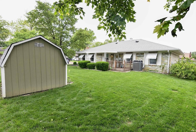 4101 Saddlebrooke Ln, Evansville, IN 47715 - back of property with a yard, cooling unit, brick siding, an outbuilding, and a gambrel roof