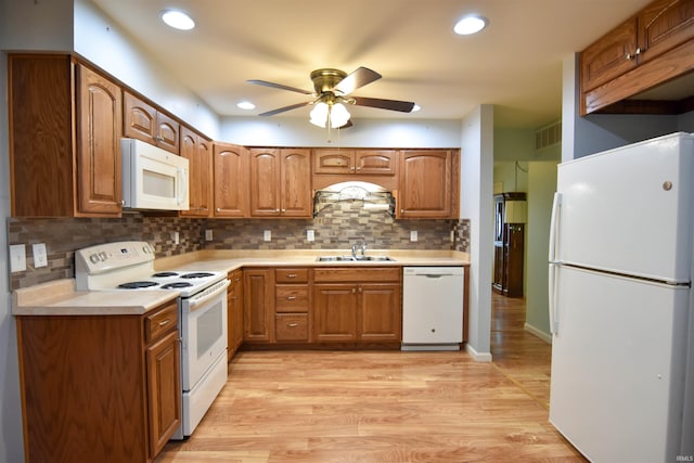 4101 Saddlebrooke Ln, Evansville, IN 47715 - kitchen featuring white appliances, a sink, a ceiling fan, brown cabinetry, and recessed lighting