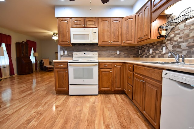 4101 Saddlebrooke Ln, Evansville, IN 47715 - kitchen with white appliances, ceiling fan, a sink, light countertops, and tasteful backsplash