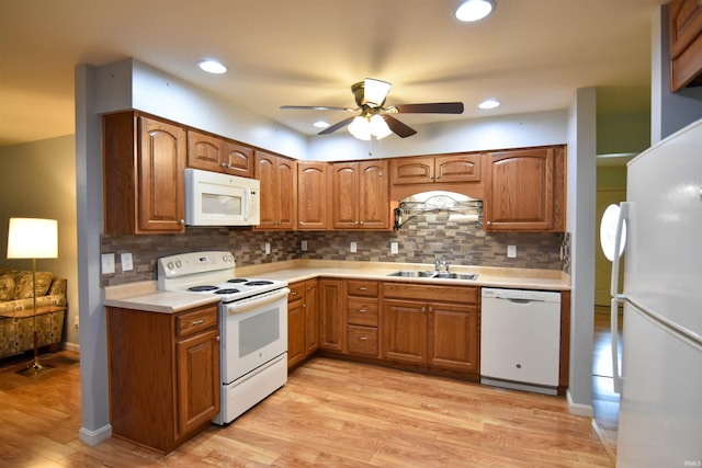 4101 Saddlebrooke Ln, Evansville, IN 47715 - kitchen with white appliances, a sink, a ceiling fan, light wood-type flooring, and light countertops
