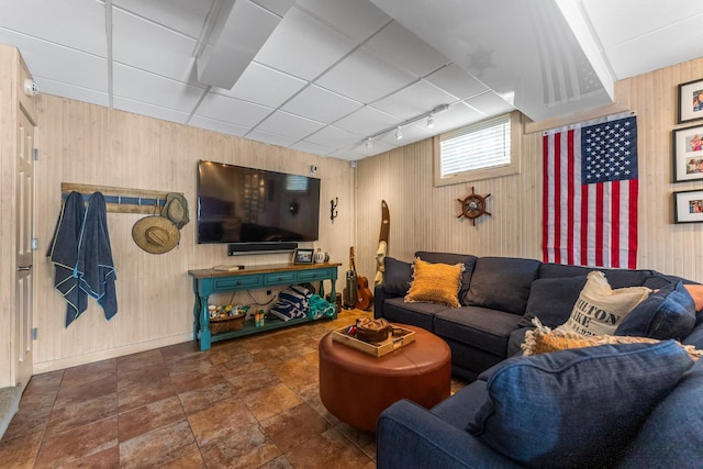 living room with wood walls and baseboards
