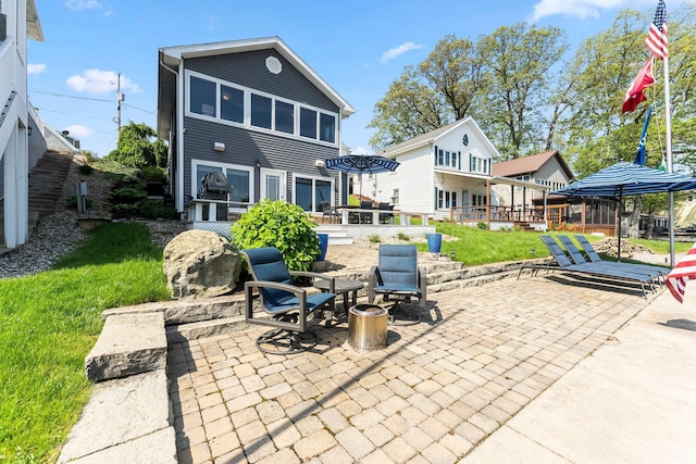 back of property with a patio area and a yard