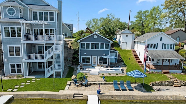 rear view of house with stairs, a wooden deck, a patio, a pergola, and a yard