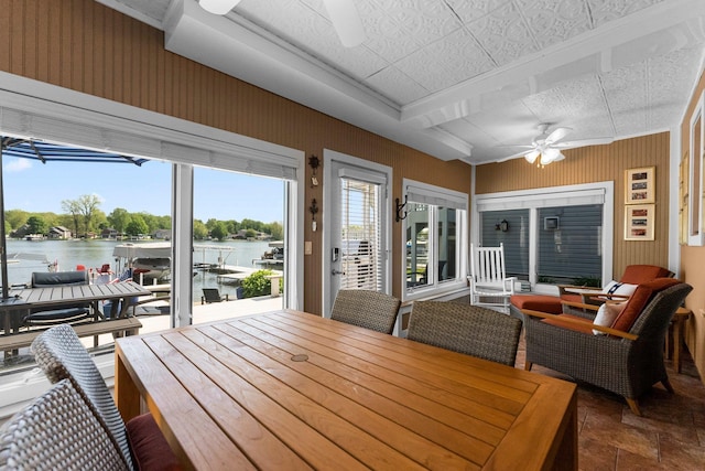 sunroom with a water view and stone finish flooring