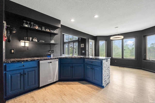 kitchen featuring stainless steel dishwasher, blue cabinetry, a sink, light wood-style floors, and a textured ceiling