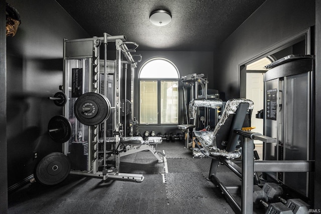 gym featuring a textured ceiling