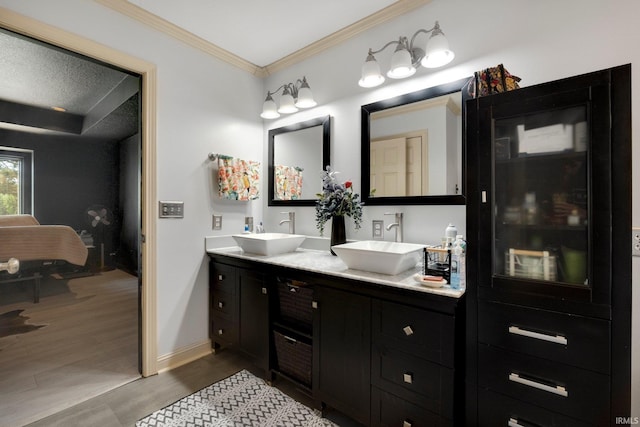 full bath featuring ornamental molding, wood finished floors, double vanity, and baseboards