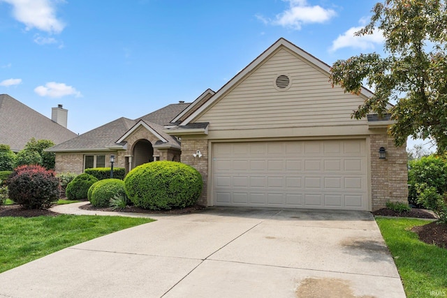 view of front of home featuring brick siding, concrete driveway, and a garage