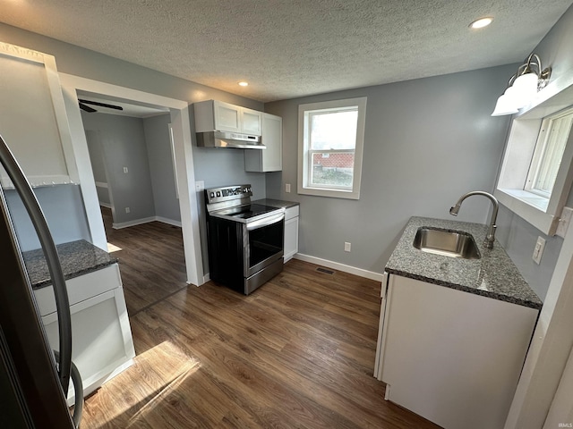 807 Walnut St, Oolitic, IN 47451 - kitchen featuring stainless steel range with electric stovetop, under cabinet range hood, a sink, a textured ceiling, and dark stone countertops